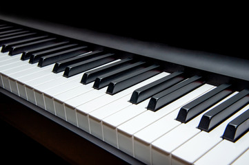 Naklejka premium piano keys on black background perspective view