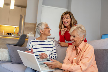 Senior friends using a laptop. Happy Senior Women Learning Computer Together. Happy Senior Women Social Group Using Internet Computer. Women using laptop