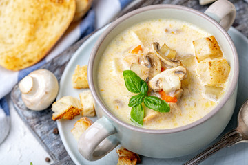 Saucepan with chicken cream soup with mushrooms.