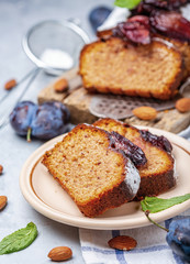 Slices of traditional plum cake on ceramic plate.