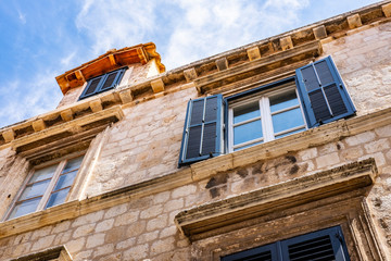 Detail of the traditional stone house and blue summer sky in Dubrovnik city, Dalmatia, Croatia