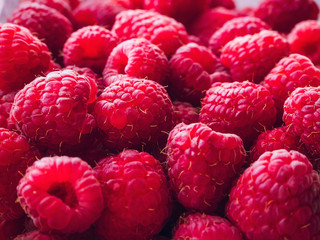 a lot of ripe raspberries close up - food background