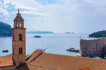 Bell tower in the historic centre of Dubrovnik, stone city walls, Adriatic Sea on blue summer day, Dalmatia, Croatia, the most popular touristic destination