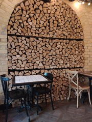 a wall of decks. firewood. kitchen interior. table with chairs