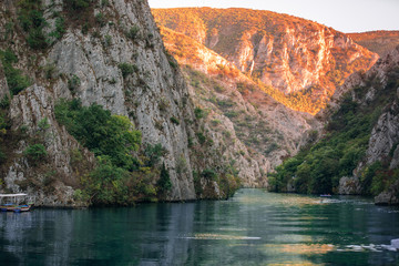 Landscape of a Mountain Lake with rocky coastline at sunset. Matka Lake in Skopje in autumn.