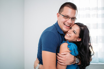 Happy couple in blue clothes hugging. Romantic gestures, happiness.