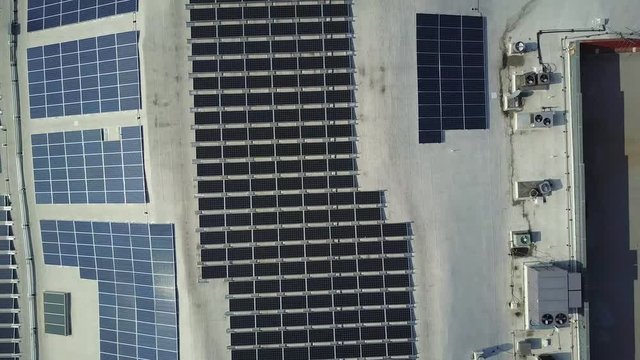 Aerial View Ascending Above Solar Panel Array On Glendale Galleria Business Building Rooftop.