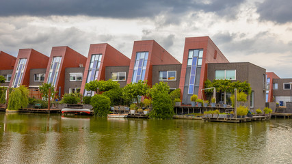 Fototapeta na wymiar Ecological waterfront houses with vertical gardens