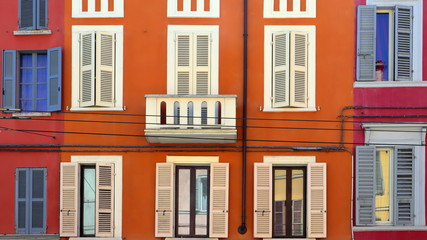 Naklejka premium windows and balcony of a colored old building