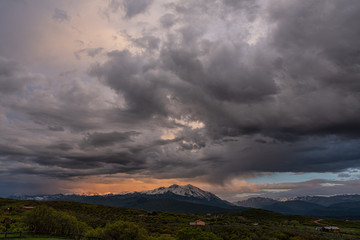 storm clouds and sunset over a mountain