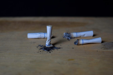 cigarettes on wooden table with black background. Smoking cigarettes concept