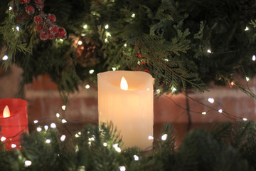 electric candles on the background of the Christmas tree and Christmas lights