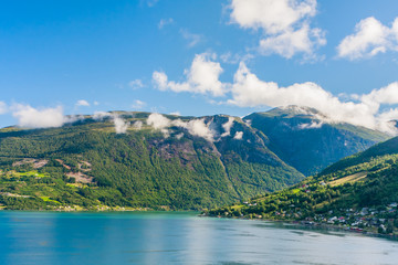 Naklejka na ściany i meble Olden, Norway, typical summer panorama of Norwegian village landscape, mountains and colorful traditional nordic houses