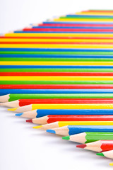 Fototapeta premium Many different colored pencils on a white background with a place for text and cory space .