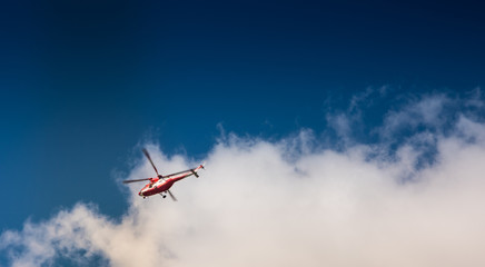 Fototapeta na wymiar Mountain Rescue helicopter (TOPR - Tatrzanskie Ochotnicze Pogotowie Ratownicze) during emergency callout in Tatra Mountains in Poland