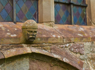 Church window with carved head detail