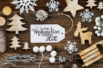 One White Label With German Text Frohe Weihnachten Und Ein Glueckliches 2020 Means Merry Christmas And A Happy 2020. Frame Of Christmas Decoration Like Tree, Sled, Star And Fir Cone.