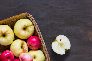 Apples in basket on the wooden background