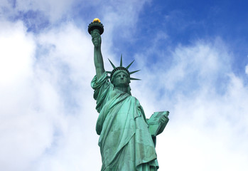 Fototapeta premium Statue of Liberty from below with blue sky and clouds on American Liberty Island in New York City, USA