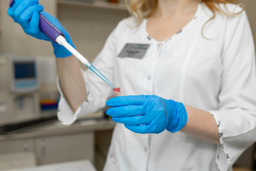 Woman lab technician take blood sample from test tube