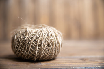 a ball of harsh thread on a wooden background