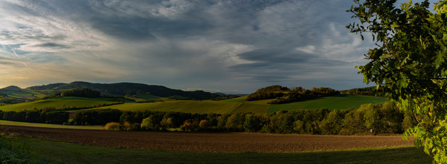Fields pasture land and meadows in sunset evening near Besiny village