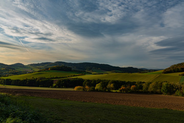 Fields pasture land and meadows in sunset evening near Besiny village