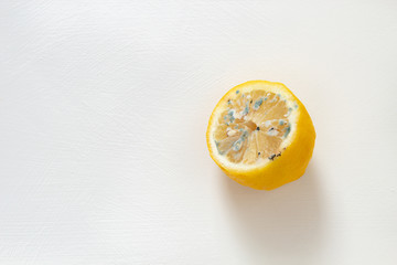 Half spoiled lemon on a white background