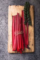 Fresh raw leaves of swiss chard,  beets, mangold, on a concrete  table, copy space