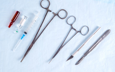 Surgical clamps, scalpel and syringes