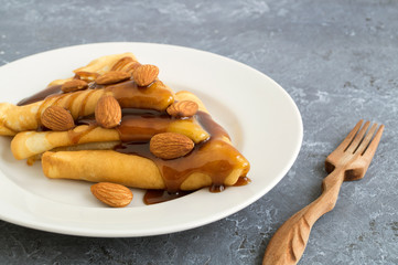 pancakes with syrup on a white plate