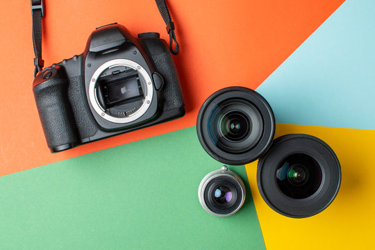 SLR camera with a set of different lenses on a colored background, the choice of device for the camera concept