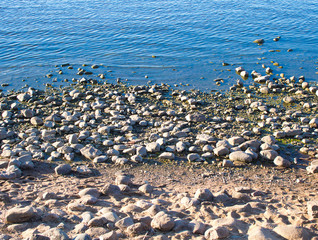 Sea waves on shore with pebble stones