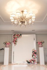 Wedding Hall. Wedding arch for the bride and groom decorated with fresh flowers