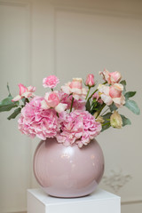 Wedding decorations. Holiday decoration vase with fresh flowers. Pink roses and carnations.