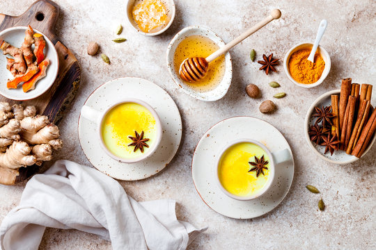 Turmeric golden milk latte with spices and honey. Detox, immune boosting, anti inflammatory healthy cozy drink