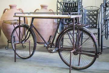 Fototapeta na wymiar Wooden Shelf Made in the Shape of an Old Bicycle