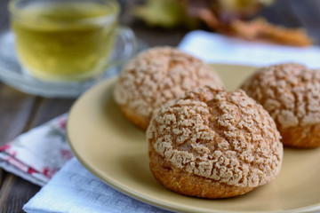 Delicious lush buns and a cup of green tea are cooked for breakfast
