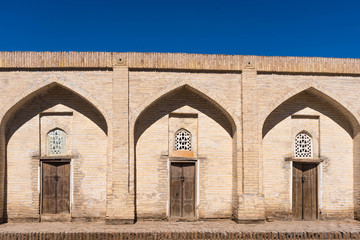 Fototapeta premium Three lanced arcs with wooden doors in the Kunya ark citadel, Khiva, Uzbekistan