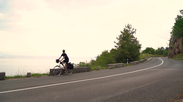 Image of a man travelling with a touring bicycle, Croatia.