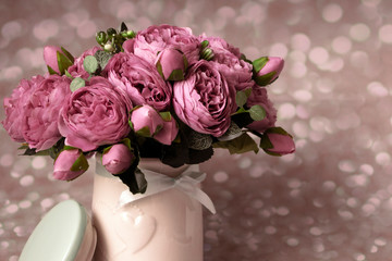 Pink peonies in vase on wooden floor and bokeh background - retro styled photo. soft focus.