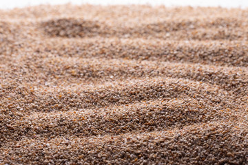 Closeup of raked sand that refers to a Zen concept