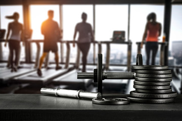 Dumbbell, barbell and workout in the gym.  Copy space with blurred gym background.