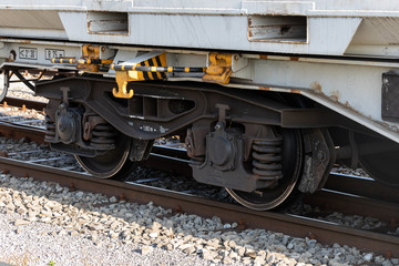 Naklejka premium brown rusted rail car wheel on rails by day