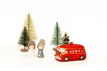 Christmas card with wooden toy dolls, Christmas trees and a red Golden handmade machine on a white background.