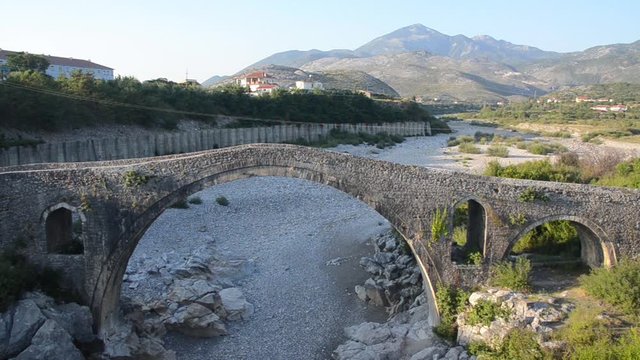 Albanian Countryside. Rural landscape in northwestern Albania, Balkans, Europe. Mountains, valley, river and hills. Mesi Bridge, Ura e Mesit, Shkoder. Monument of Postrib&euml; culture. Tourist attraction.