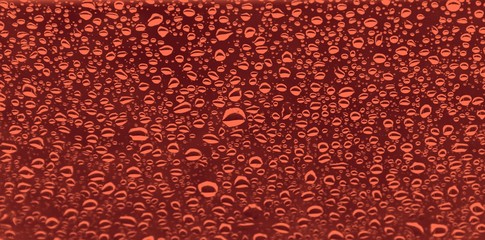 drops of water on glass in colors