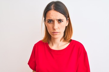 Fototapeta premium Beautiful redhead woman wearing casual red t-shirt over isolated background depressed and worry for distress, crying angry and afraid. Sad expression.