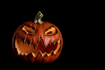 halloween pumpkin with scary face on black background