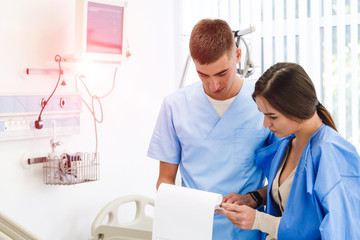 Doctor physician consulting with female patient in hospital exam room. Checking medical results. Medical treatment. Clinic.